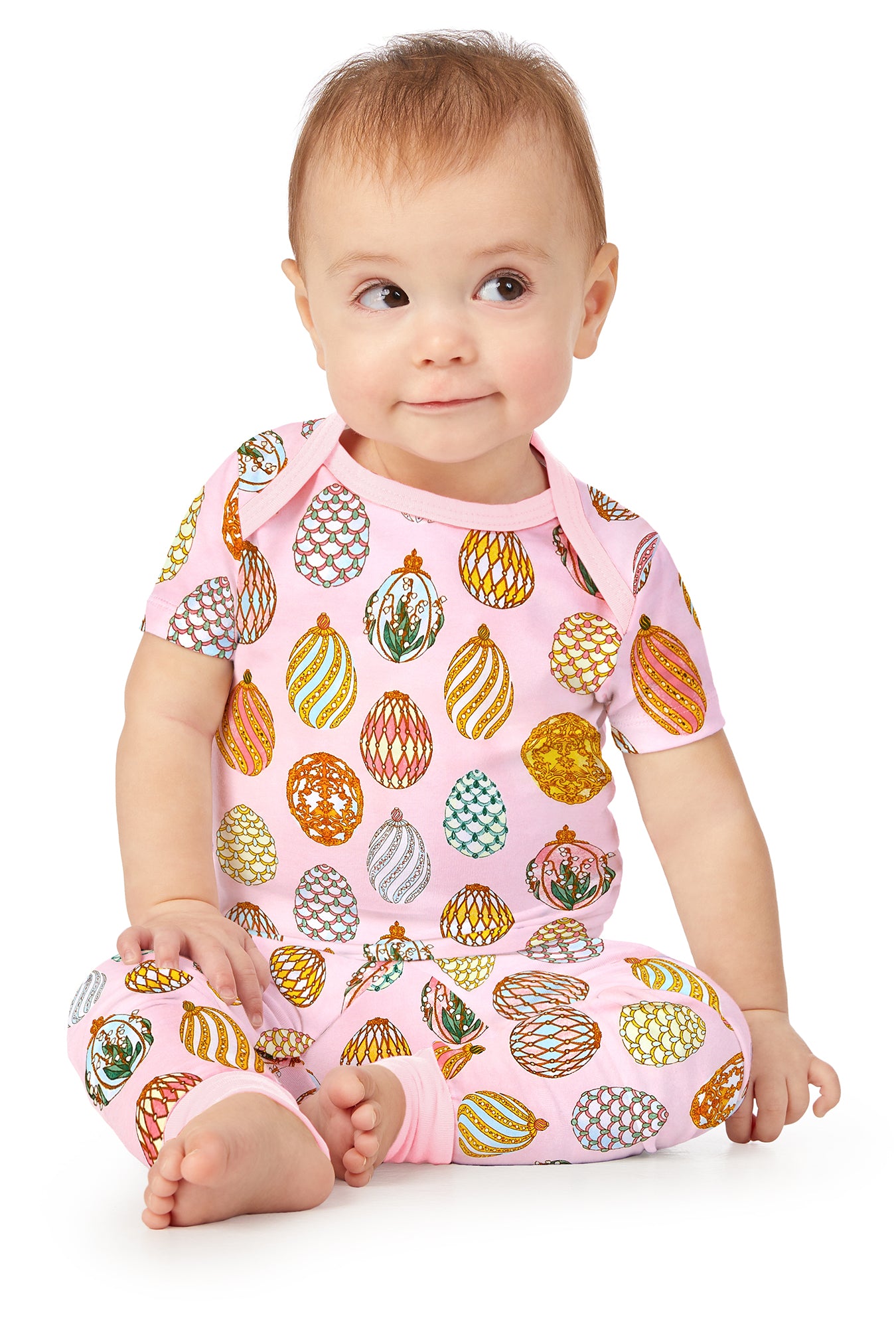A toddler wearing pink short sleeve pj set with egg hunt print