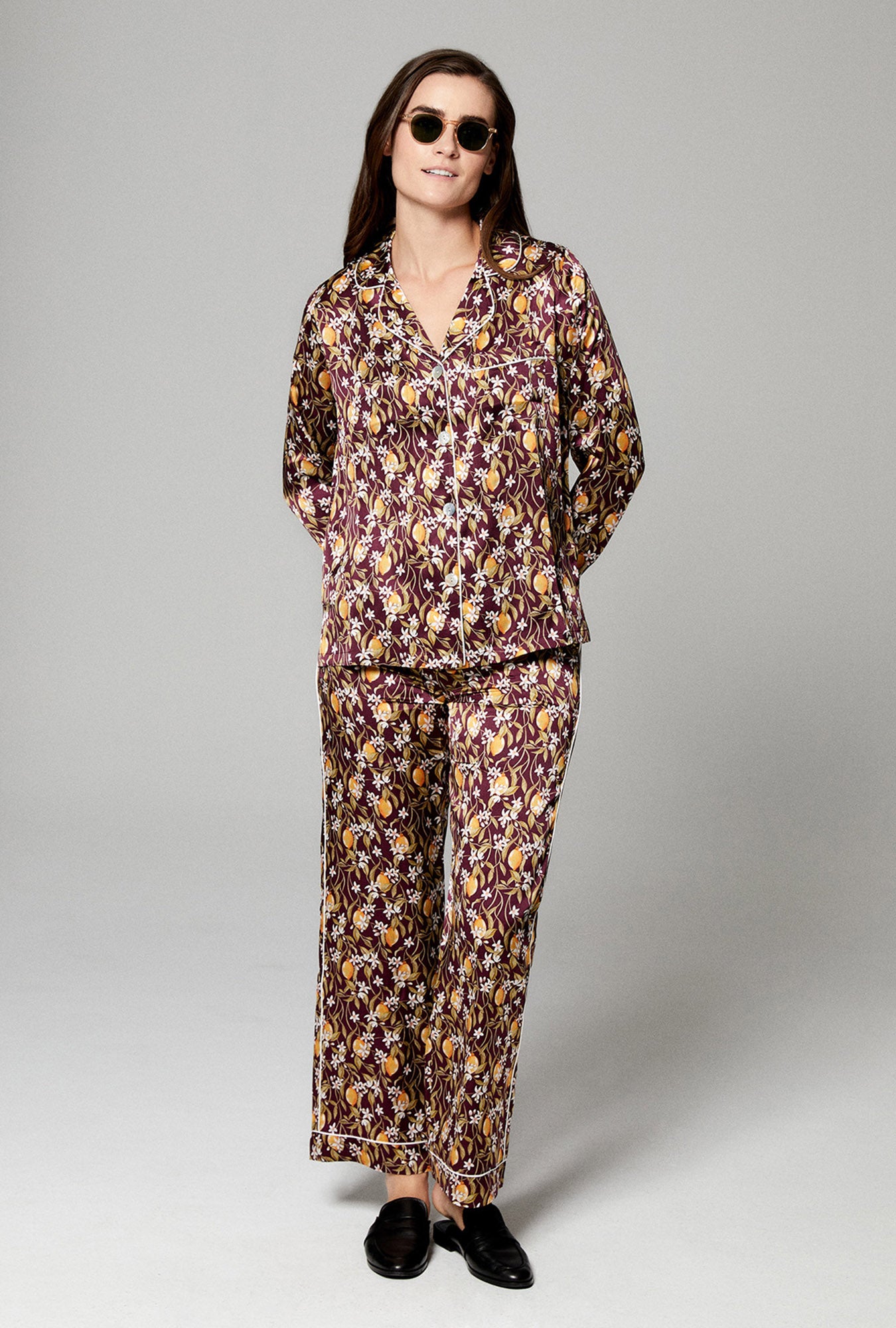 A lady wearing burgundy long sleeve pj set with floral print