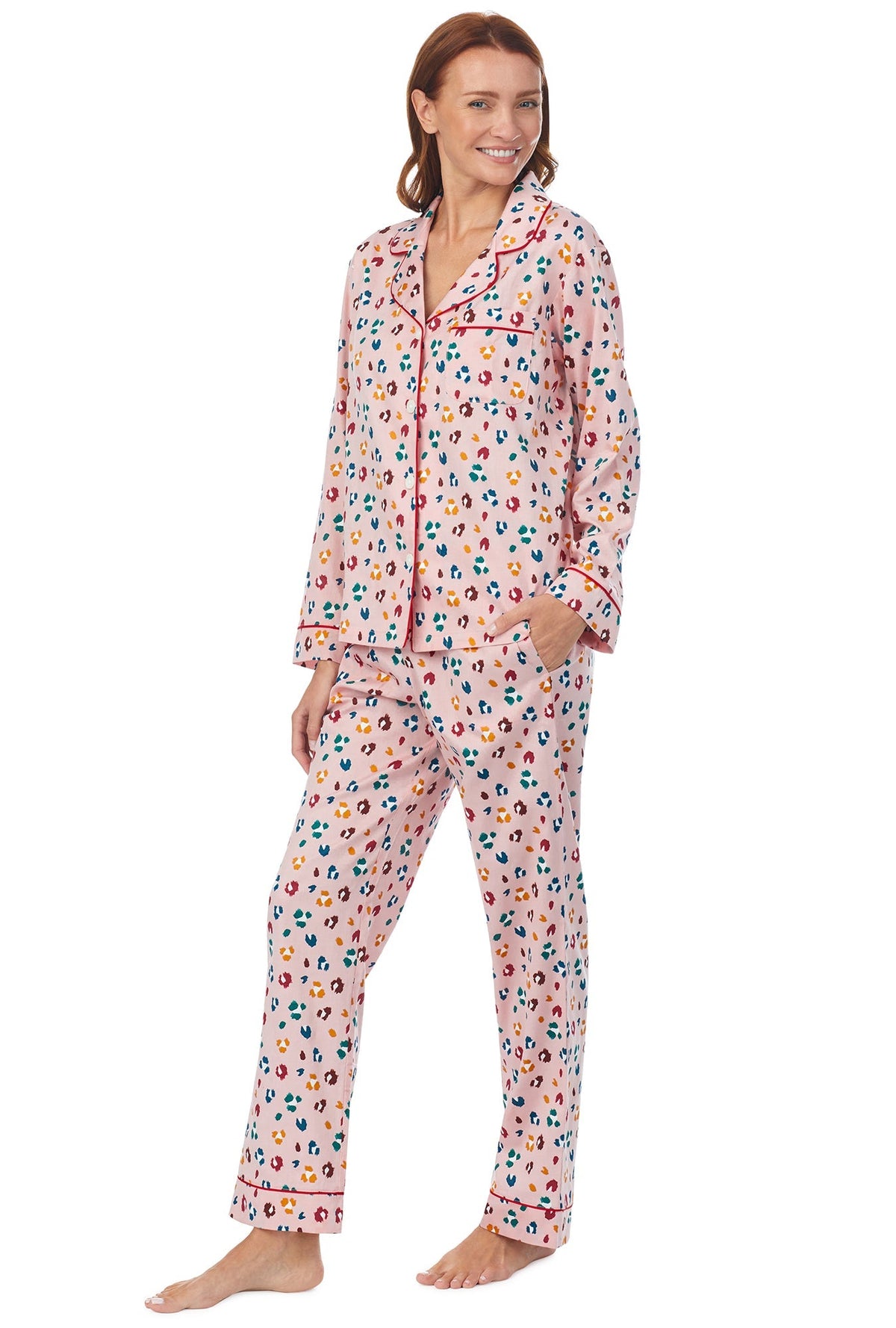 A lady wearing a long sleeve pj set with multicolor pattern. 