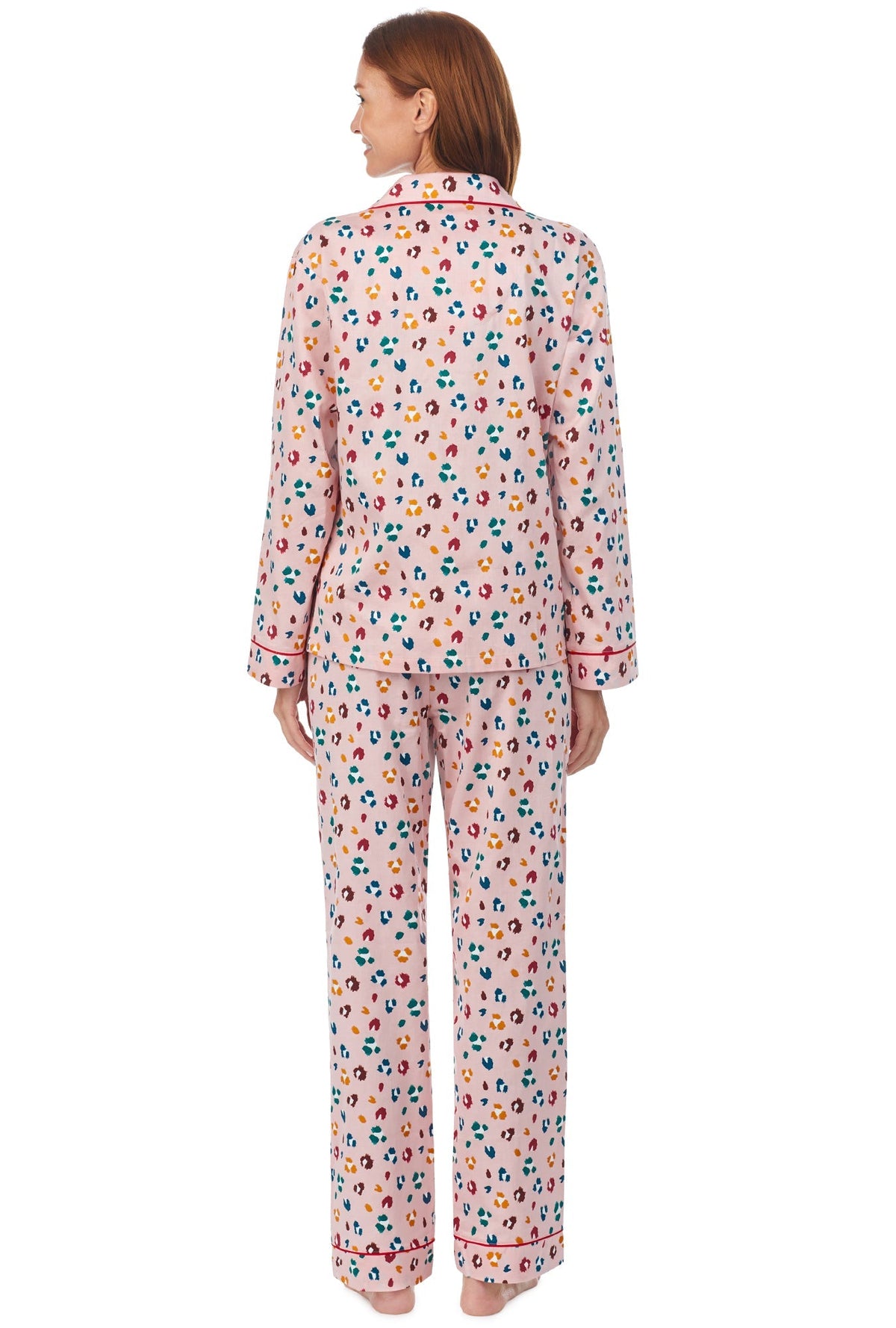 A lady wearing a long sleeve pj set with multicolor pattern. 