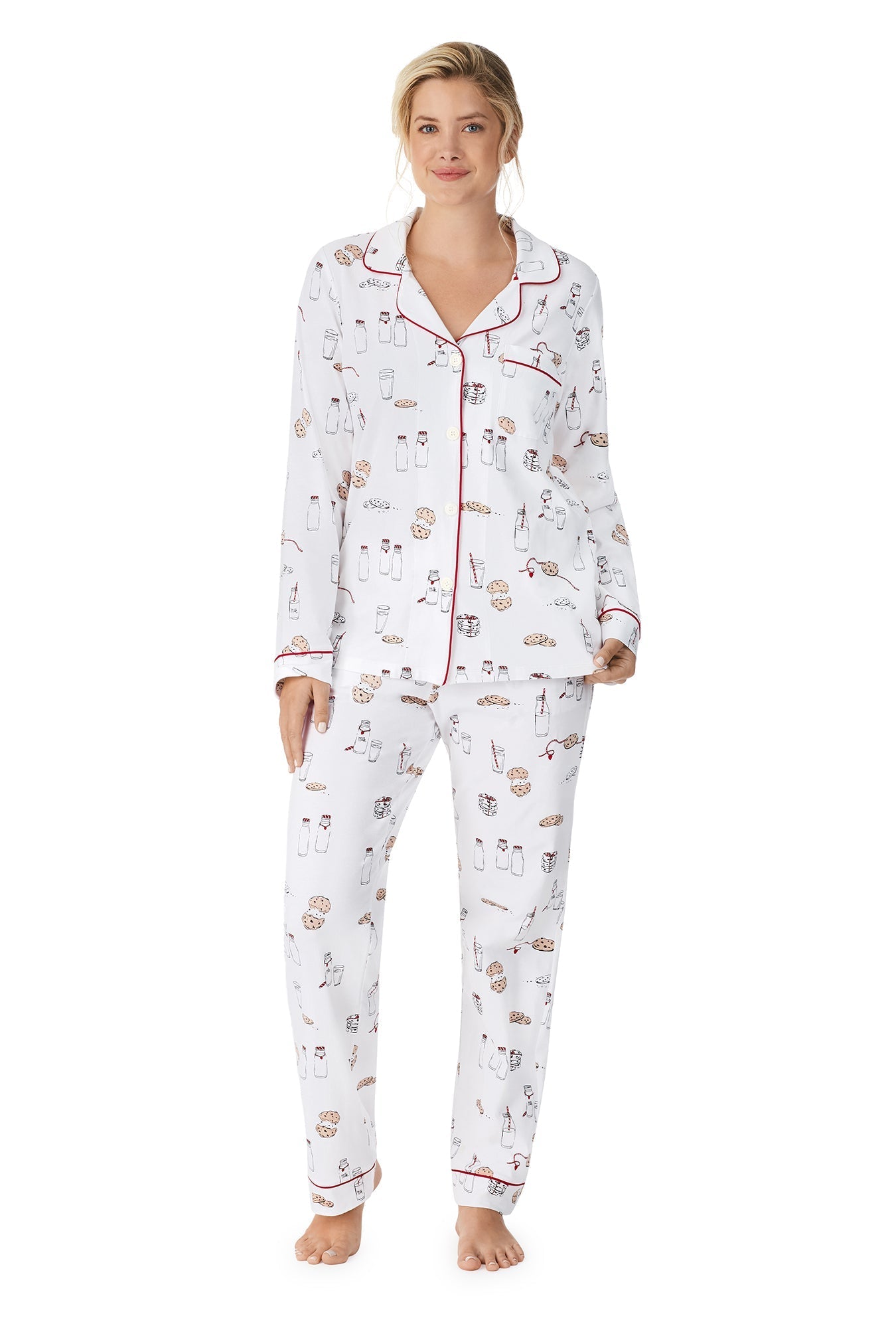 A lady wearing a white long sleeve pj set with milk and cookies pattern. 