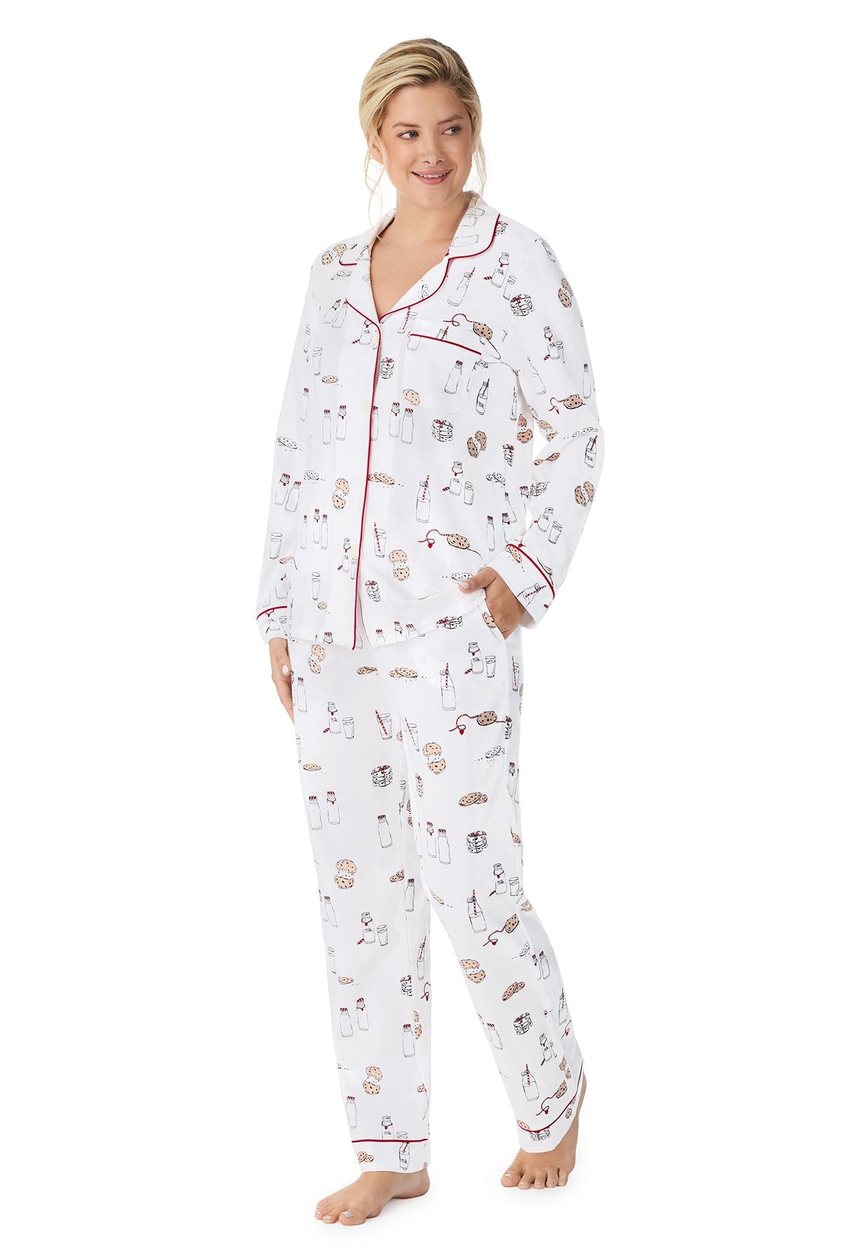A lady wearing a white long sleeve pj set with milk and cookies pattern. 