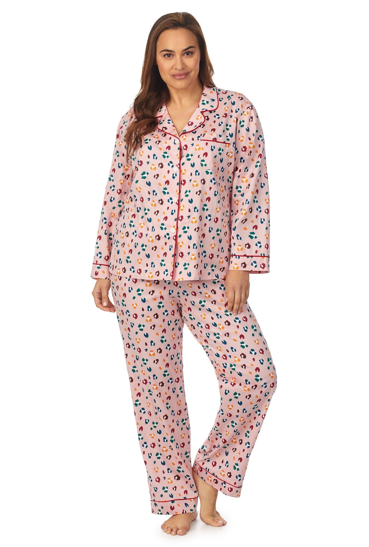 A lady wearing a long sleeve plus size pj set with multicolor pattern. 