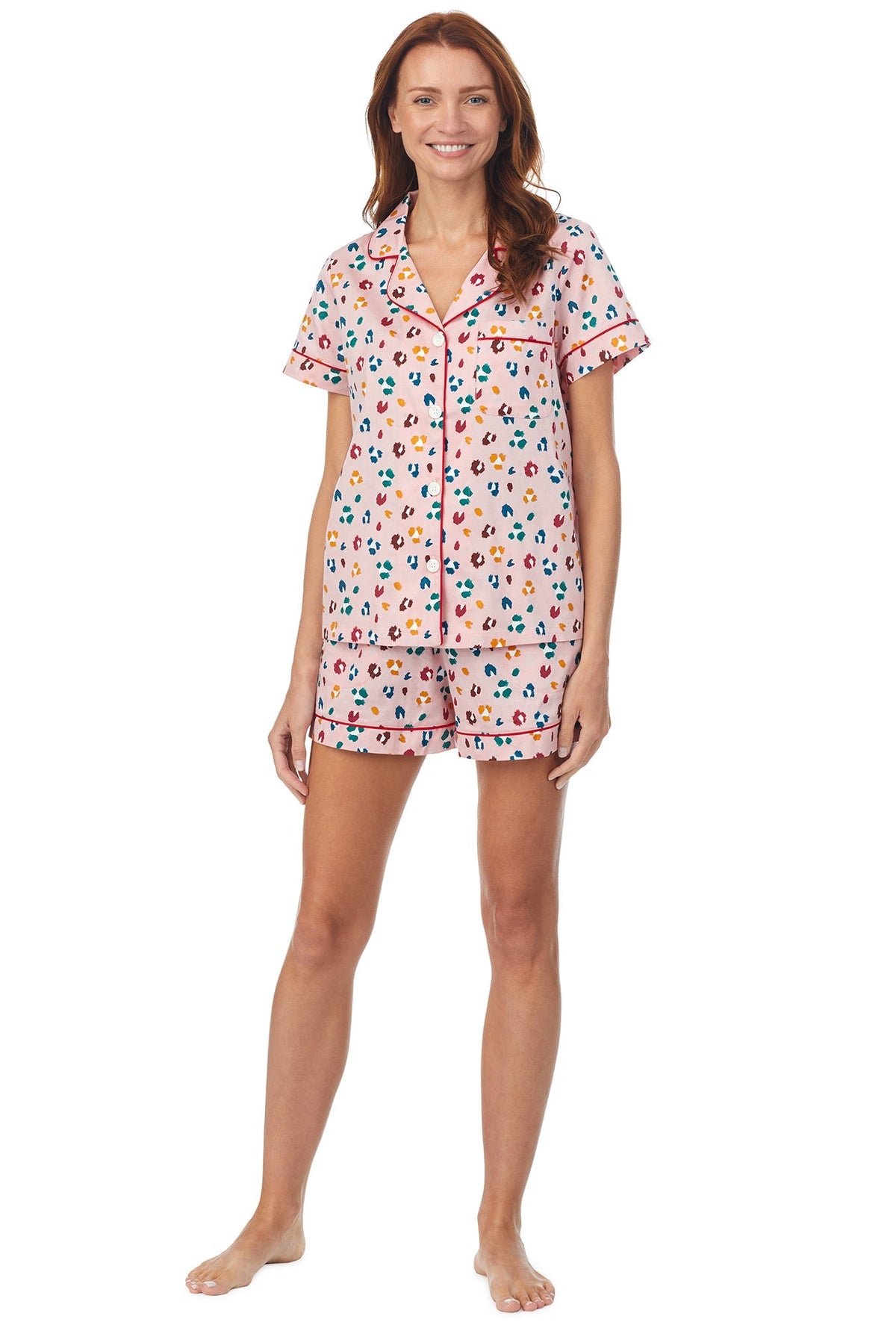 A lady wearing a short sleeve pj set with multicolor pattern. 