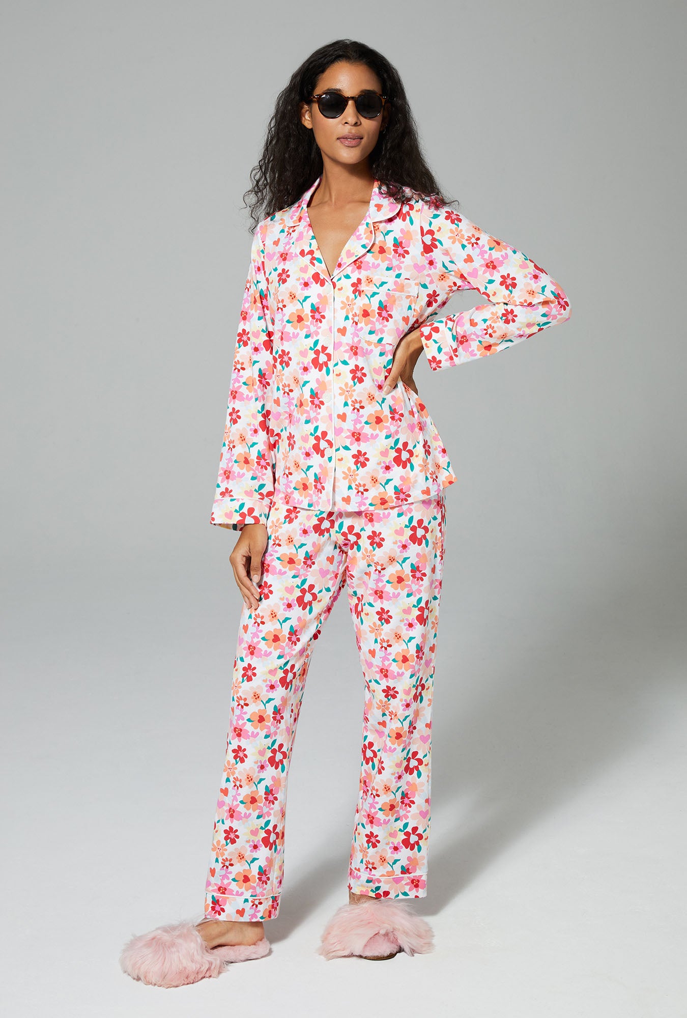 A lady wearing white long sleeve classic stretch jersey pj set with hearts and flowers print