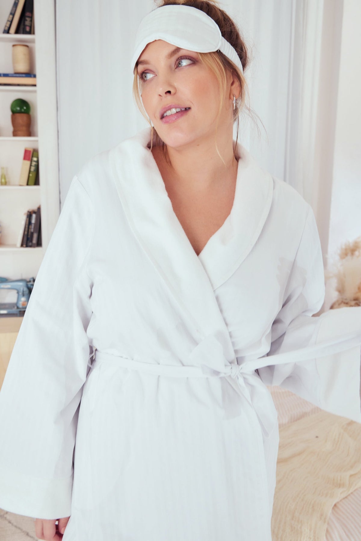 Upper body of A lady wearing plus size white robe with stripes