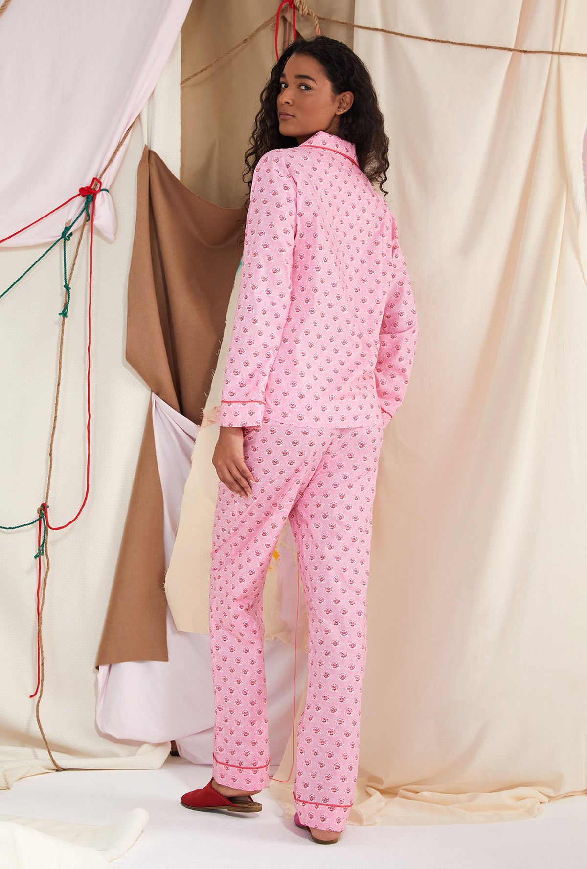 A lady wearing pink long sleeve classic pj set with corsage print
