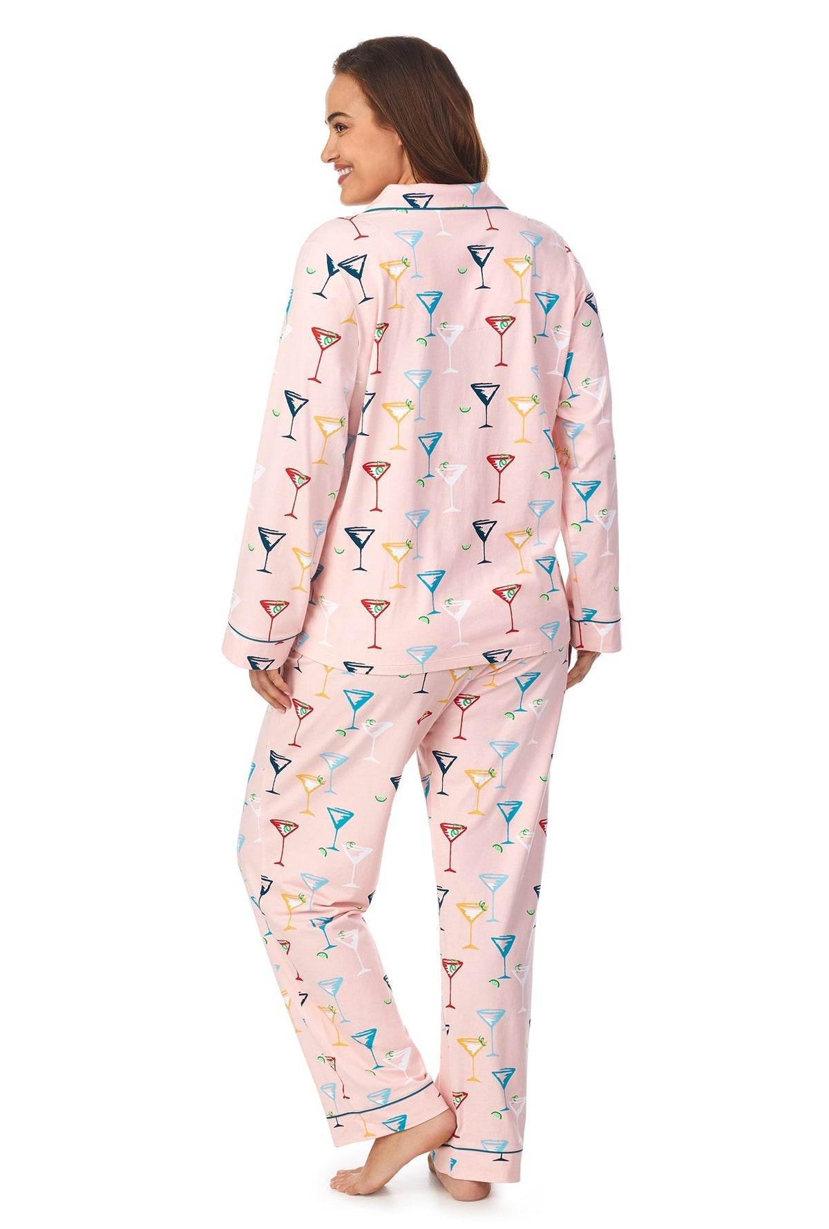 A lady wearing a pink long sleeve plus size pj set with glass pattern.