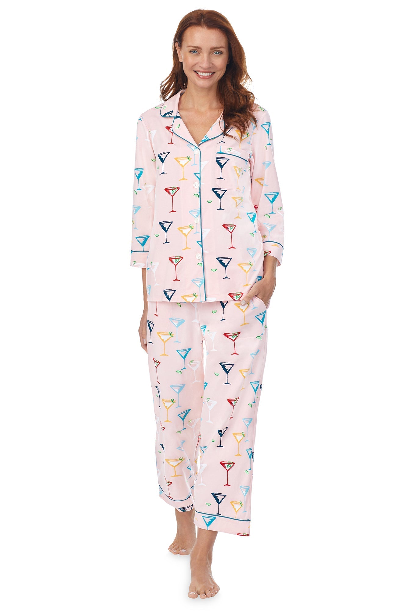A lady wearing a pink quarter sleeve cropped pj set with glass pattern.