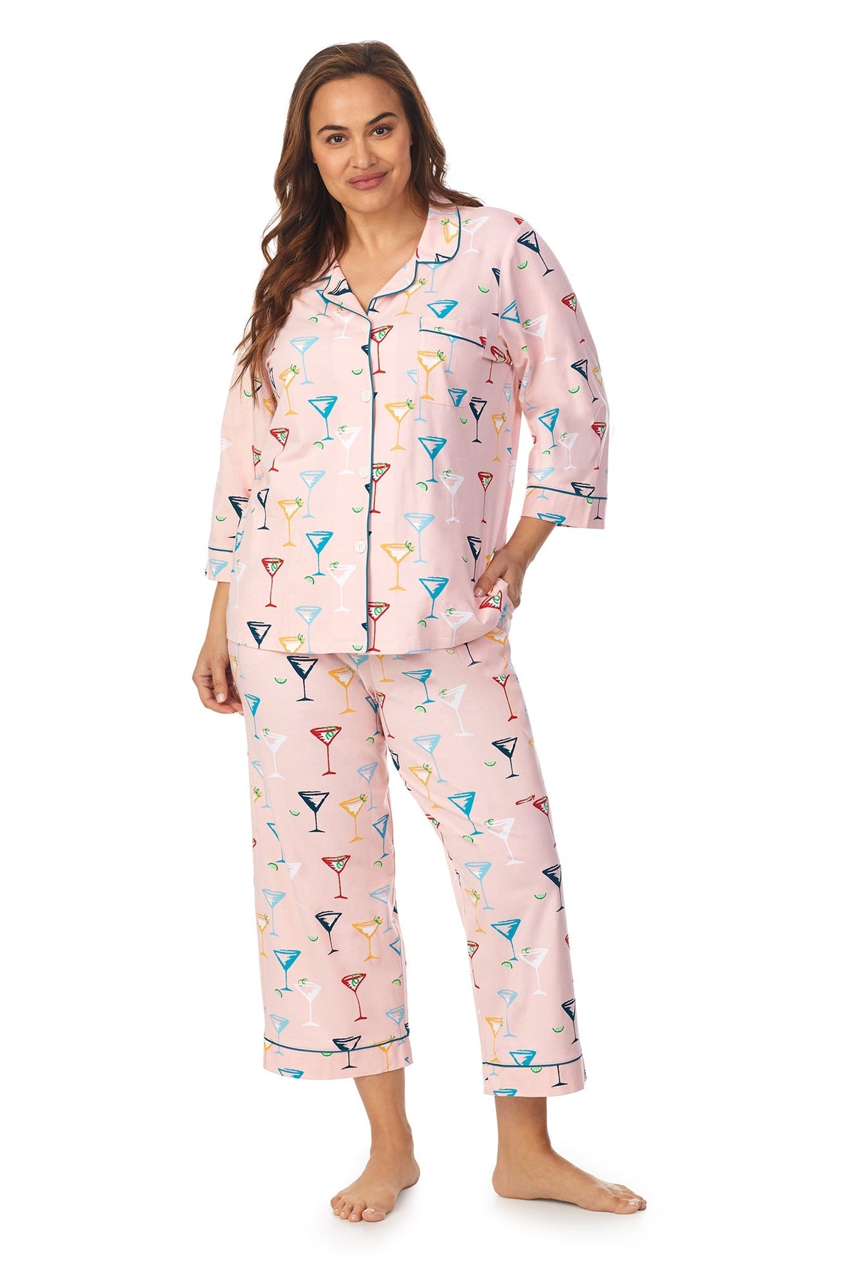 A lady wearing a pink quarter sleeve cropped plus size pj set with glass pattern.