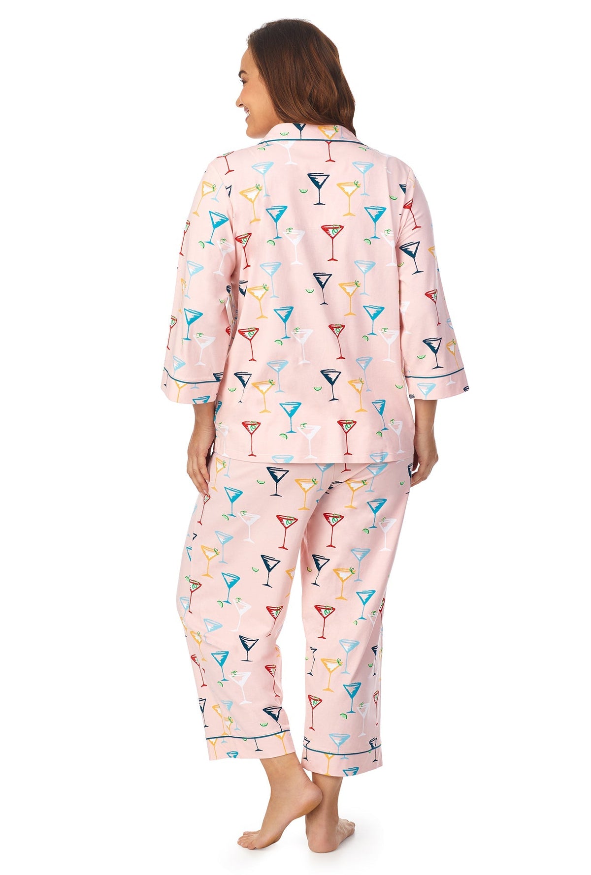 A lady wearing a pink quarter sleeve cropped plus size pj set with glass pattern.
