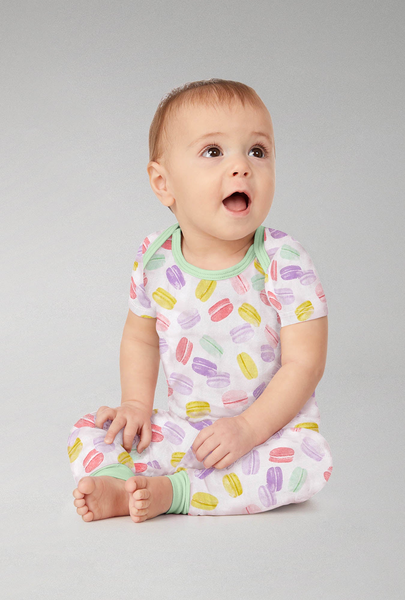 A baby wearing  Short Sleeve Stretch Jersey Boo Boo PJ Set with Delice De Macarons print