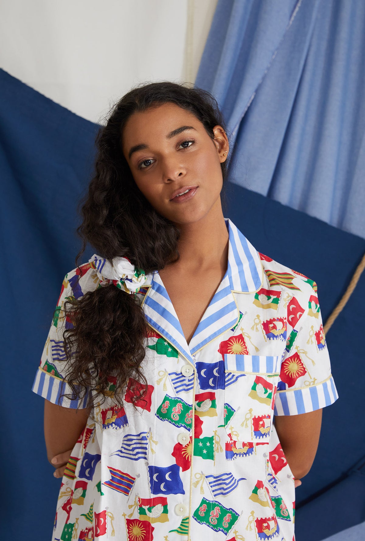 A lady wearing cotton poplin scrunchie with nautical flags print.