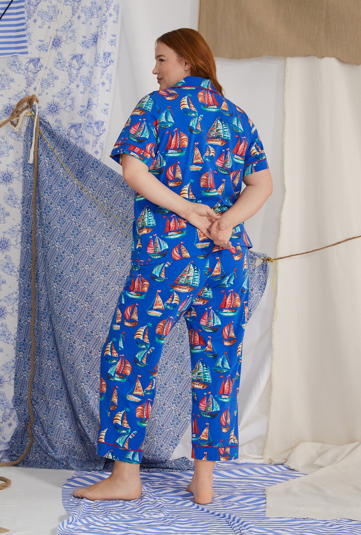A lady wearing blue short sleeve classic stretch jersey cropped plus size pj set with co sail away print.