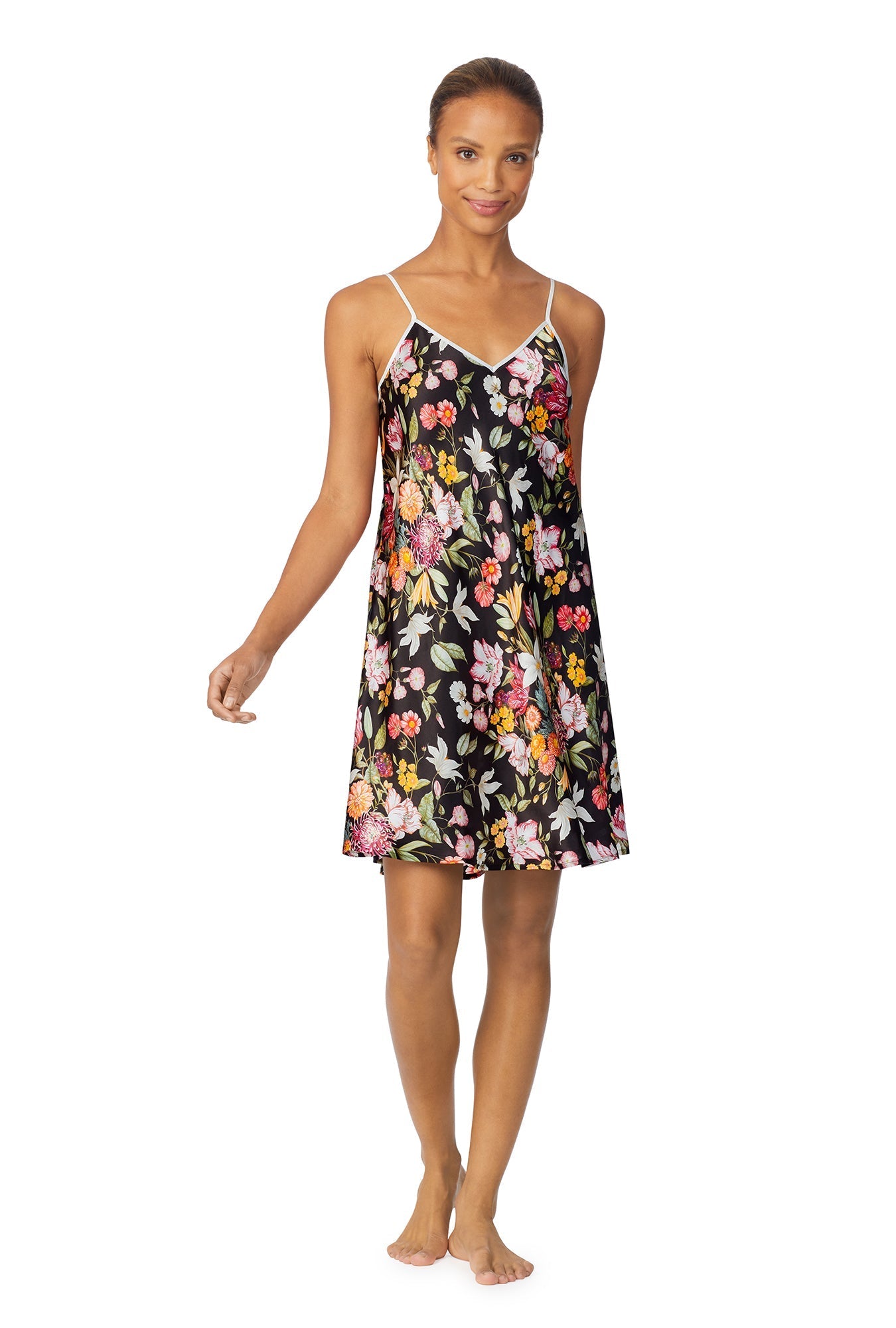 A lady wearing a black sleeveless chemise with multicolor floral pattern.
