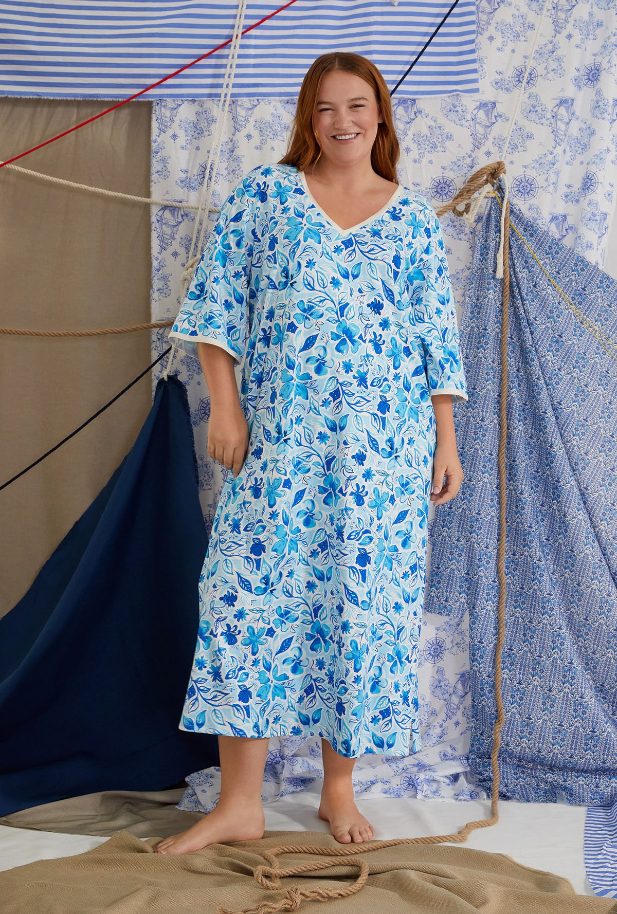 A lady wearing white quarter sleeve classic plus size caftan with marine meadows print.