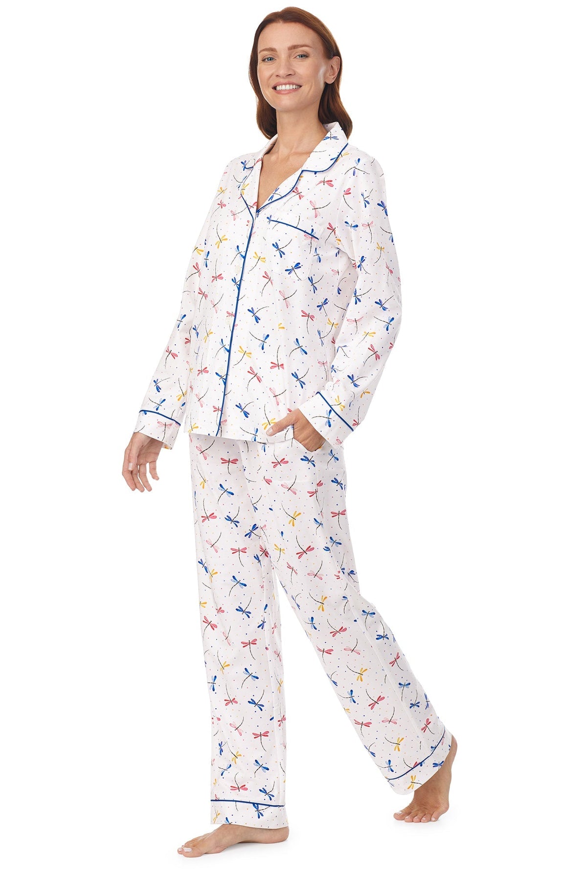 A lady wearing a white long sleeve pj set with dragonfly pattern.