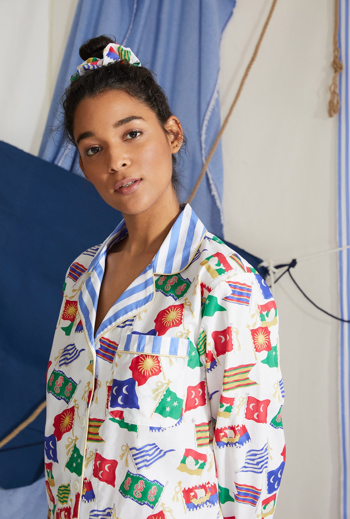 A lady wearing white long sleeve classic pj set with nautical flags print.