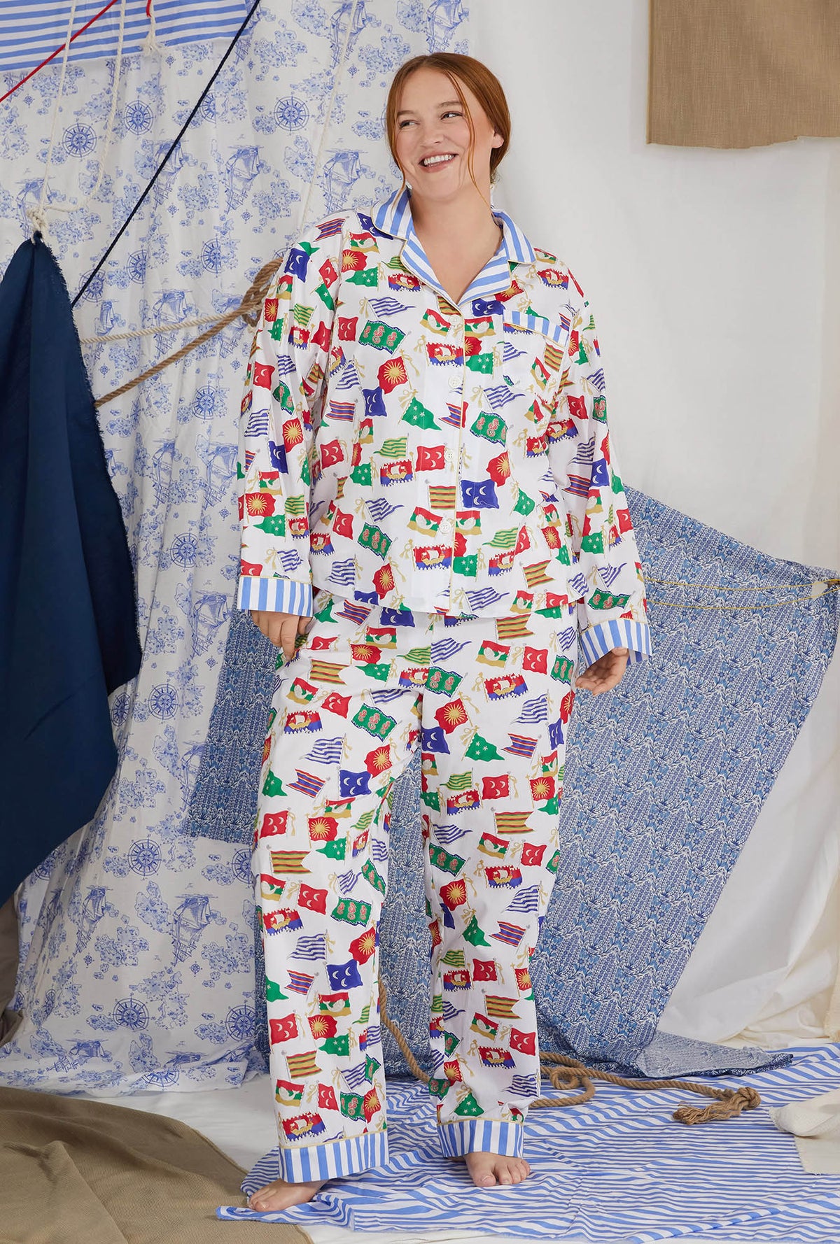 A lady wearing white long sleeve classic plus size pj set with nautical flags print.