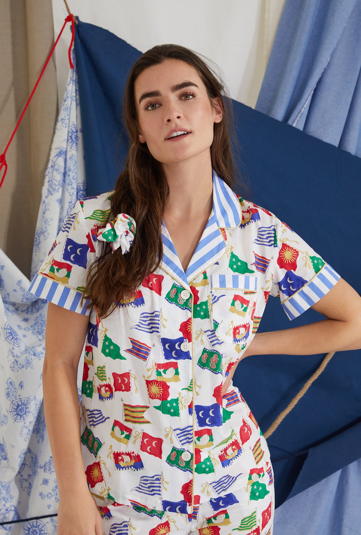 A lady wearing white short sleeve classic cropped pj set with nautical flags print.