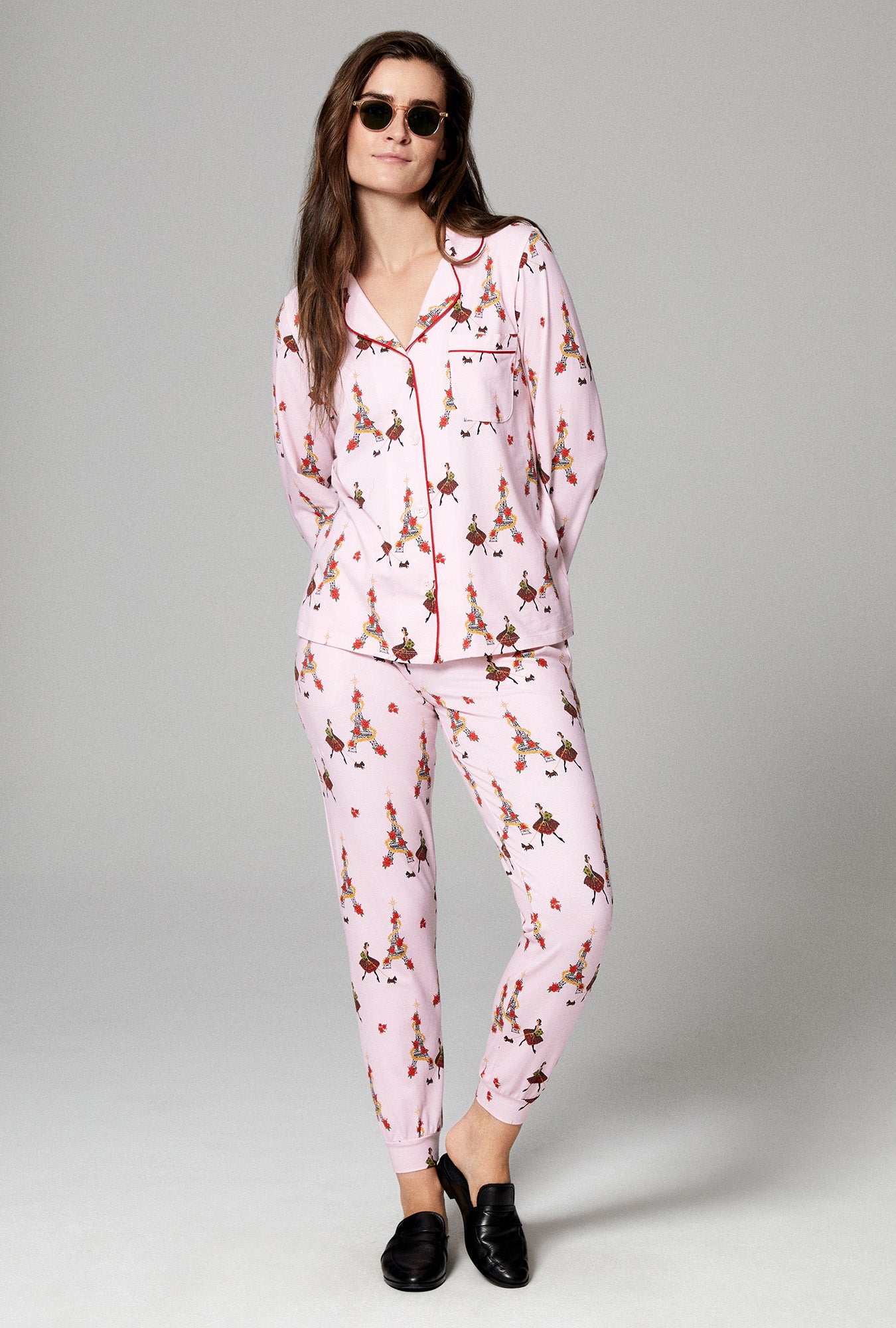 A lady wearing pink long sleeve and jogger embroidered stretch jersey pj set with christmas chic print.
