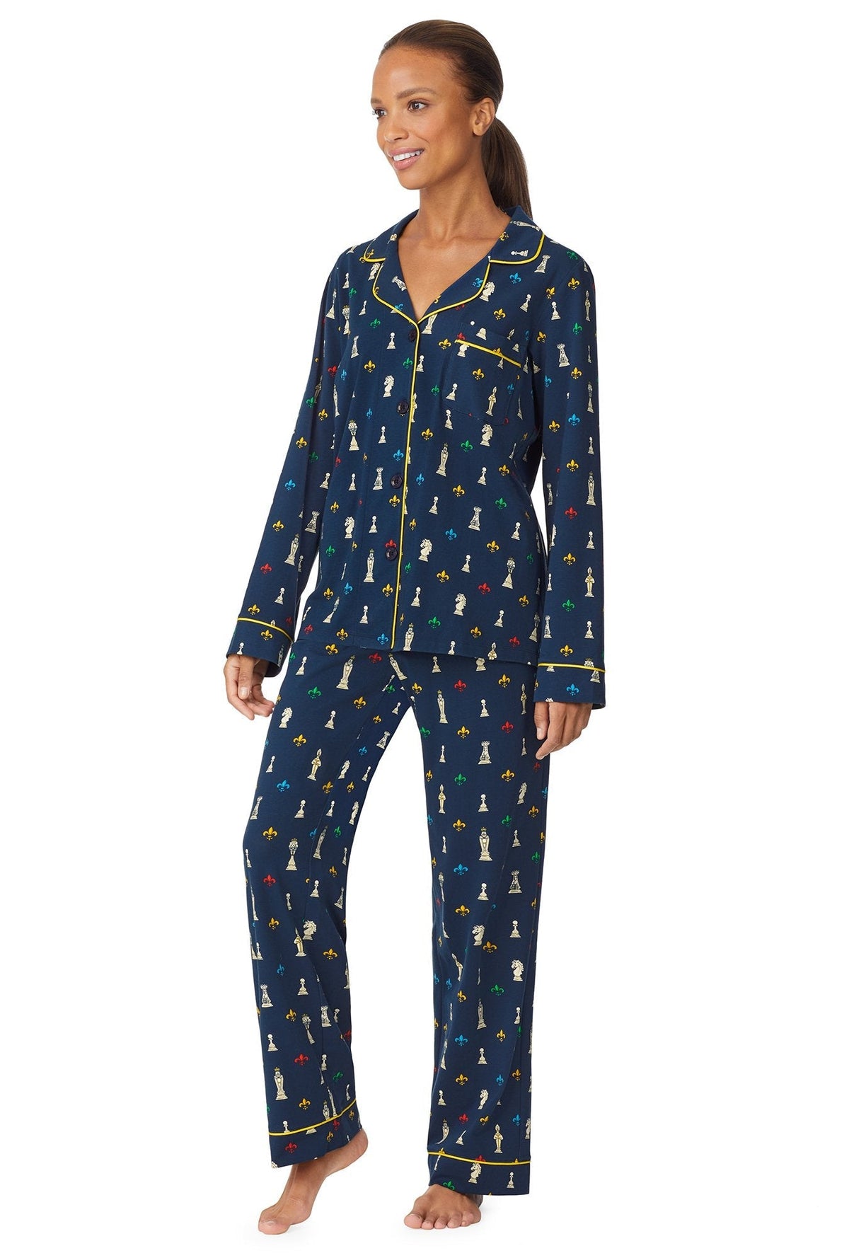 A girl wearing a navy blue long sleeve stretch jersey pj set with checkmate pattern.