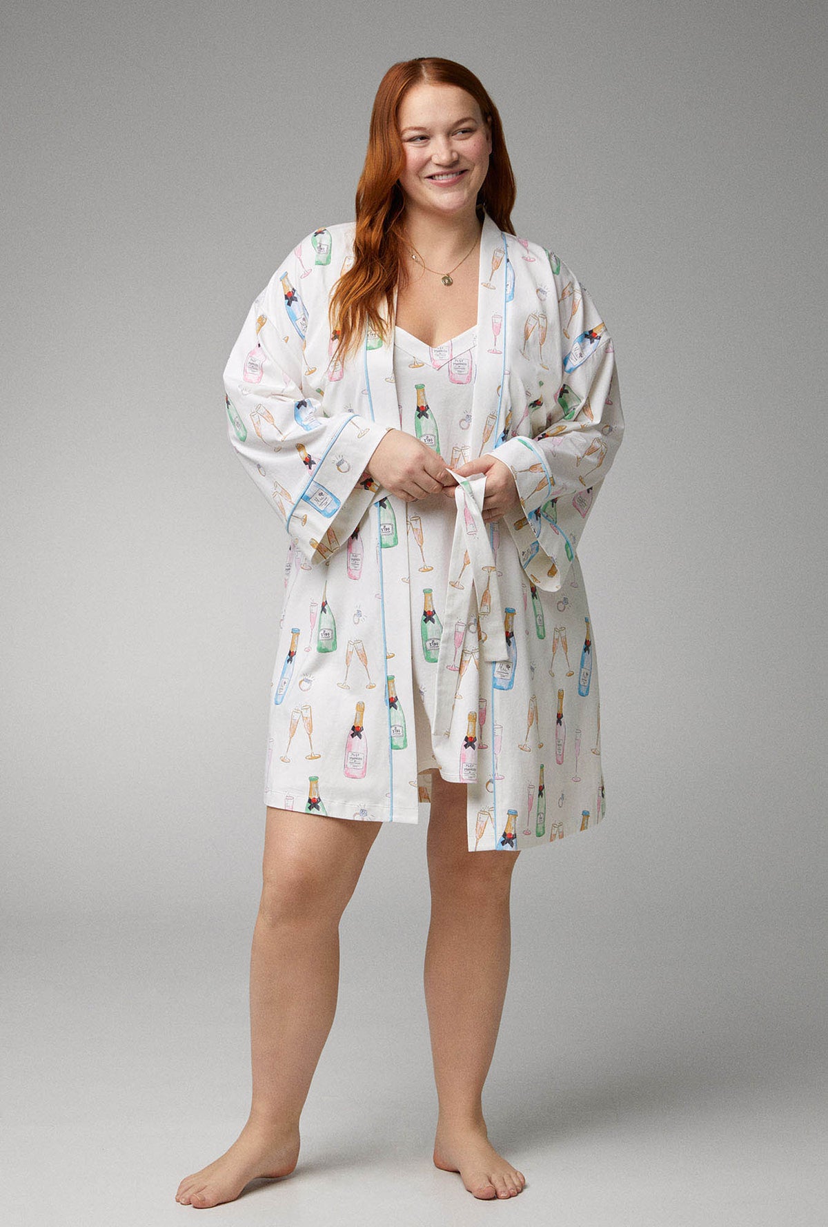 A lady wearing white Banded Collar Stretch Jersey Robe with Champagne Wedding print