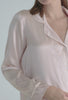 A lady wearing pink long sleeve classic pj set
