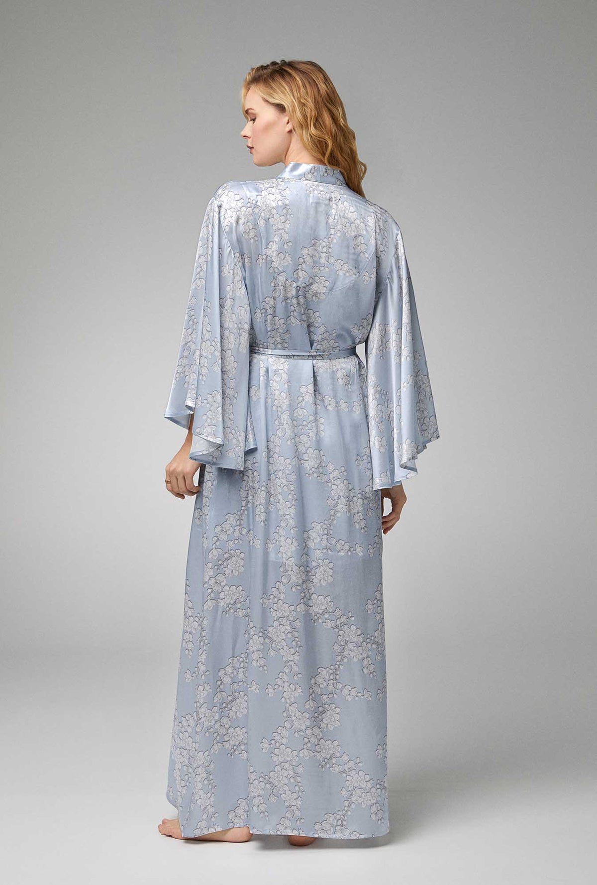 A lady wearing blue Banded Collar Woven Silk Satin Maxi Robe with Renee&#39;s Blossom print