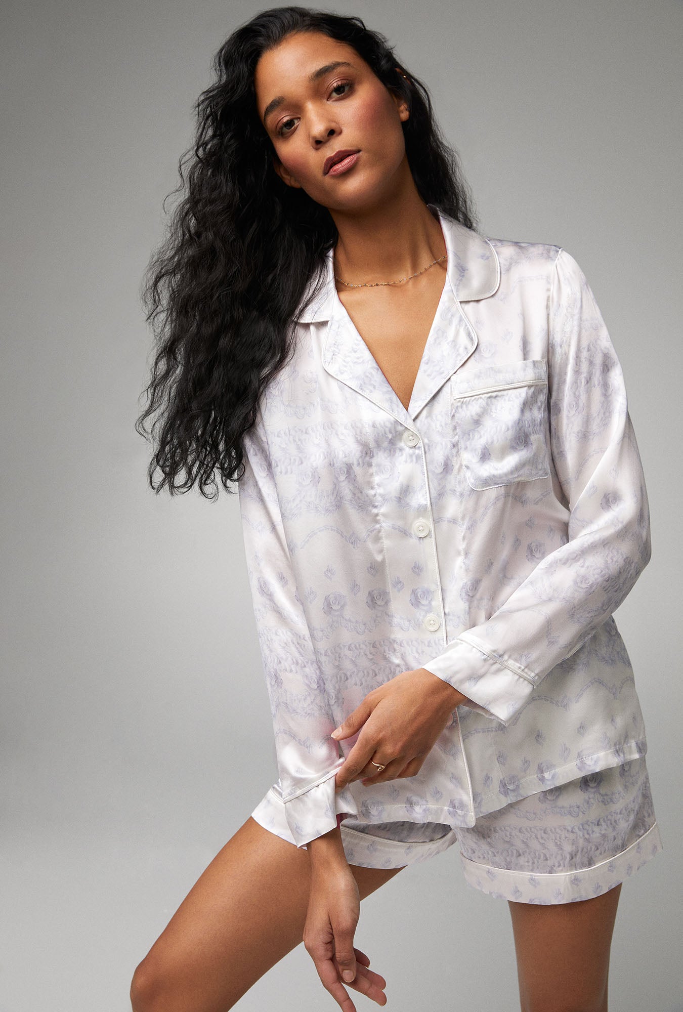 A lady wearing white long sleeve classic woven silk satin shorty pj set with buttercream print