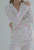 A lady wearing white long sleeve classic pj set with cottontail print