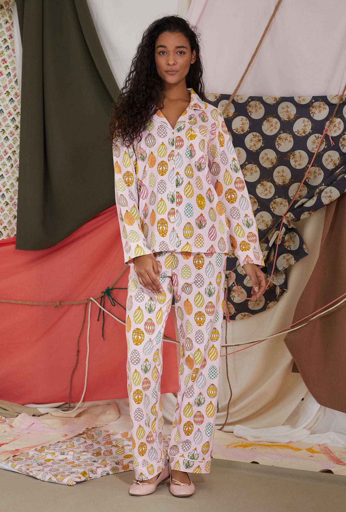 A lady wearing pink long sleeve pj set with egg hunt print