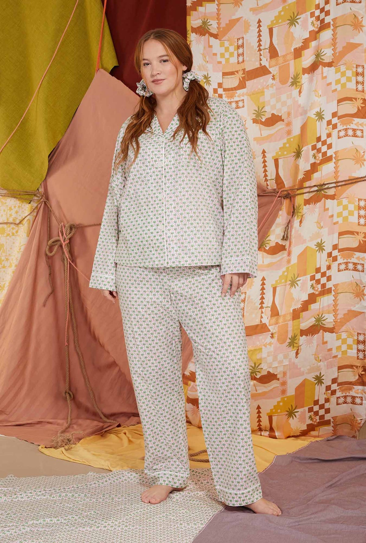 A lady wearing multicolor long sleeve clasic woven cotton poplin plus size pj set with palm geo print.