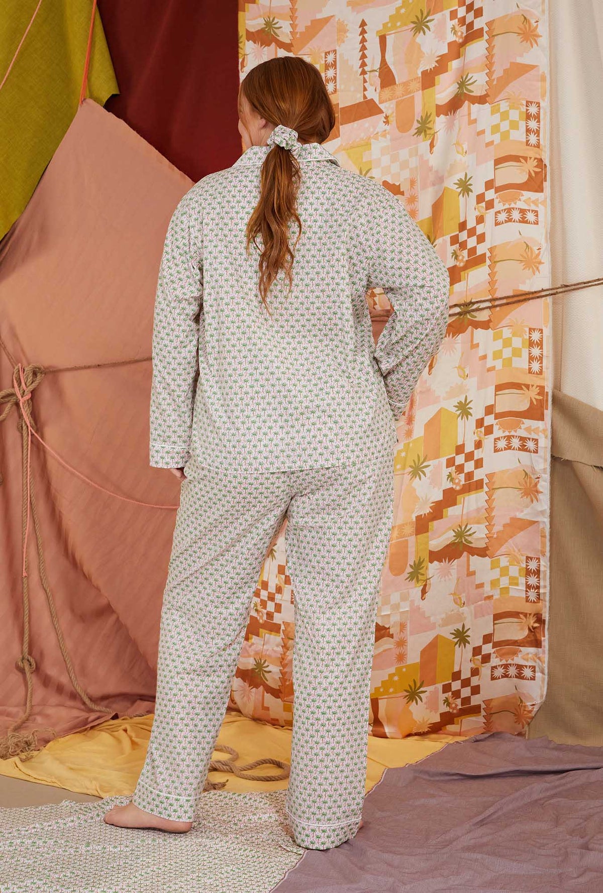 A lady wearing multicolor long sleeve clasic woven cotton poplin plus size pj set with palm geo print.