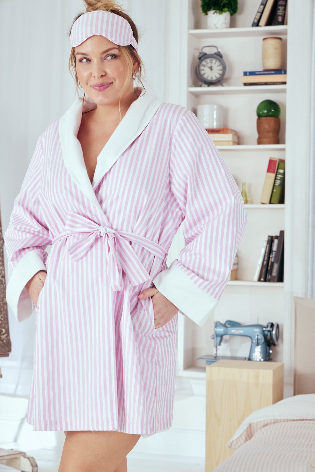 A lady wearing a pink and white stripes plus size robe.