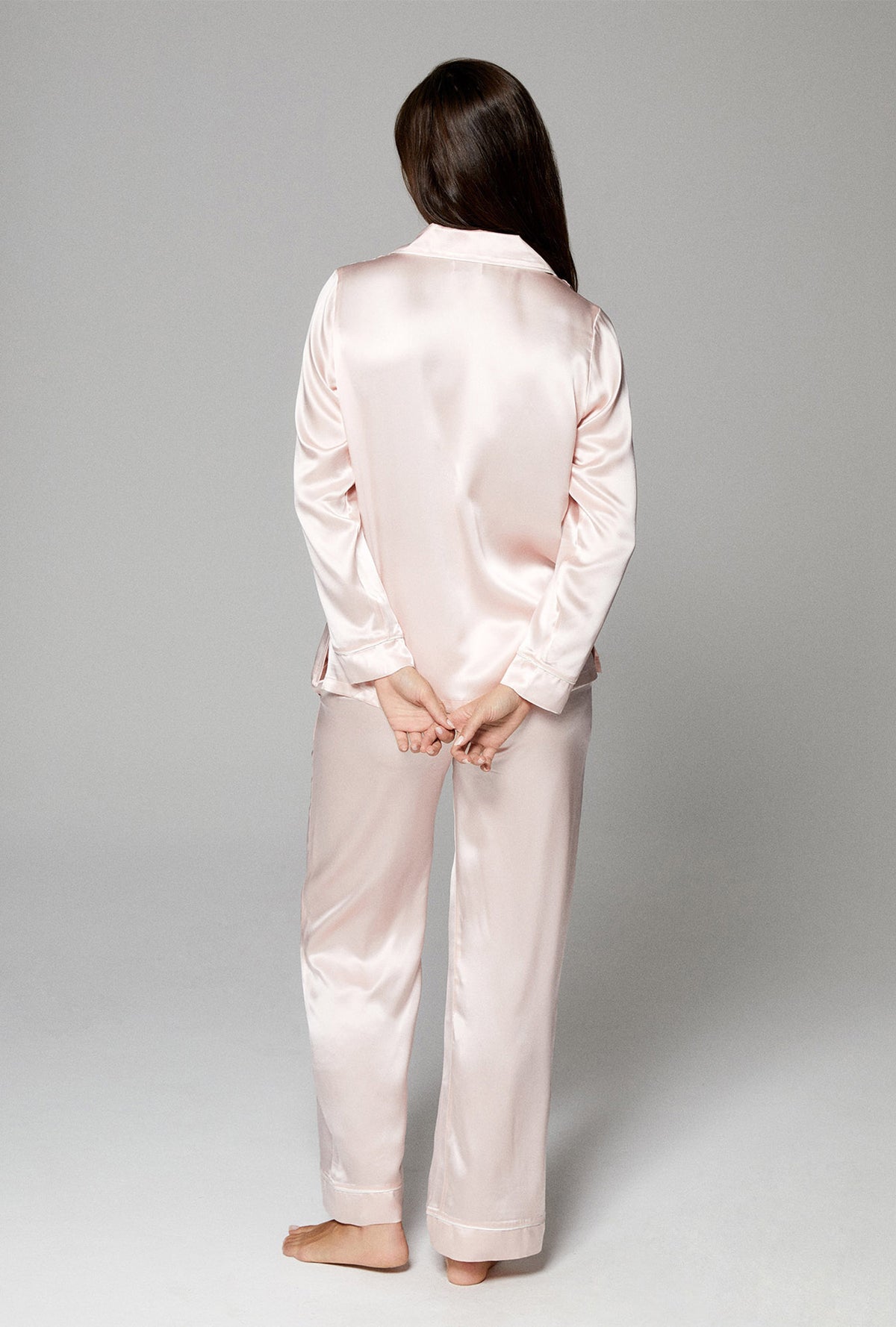 A lady wearing pink long sleeve classic pj set