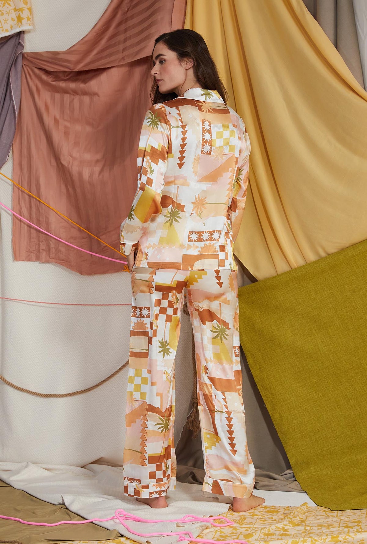 A lady wearing yellow long sleeve silk pj set with havana print