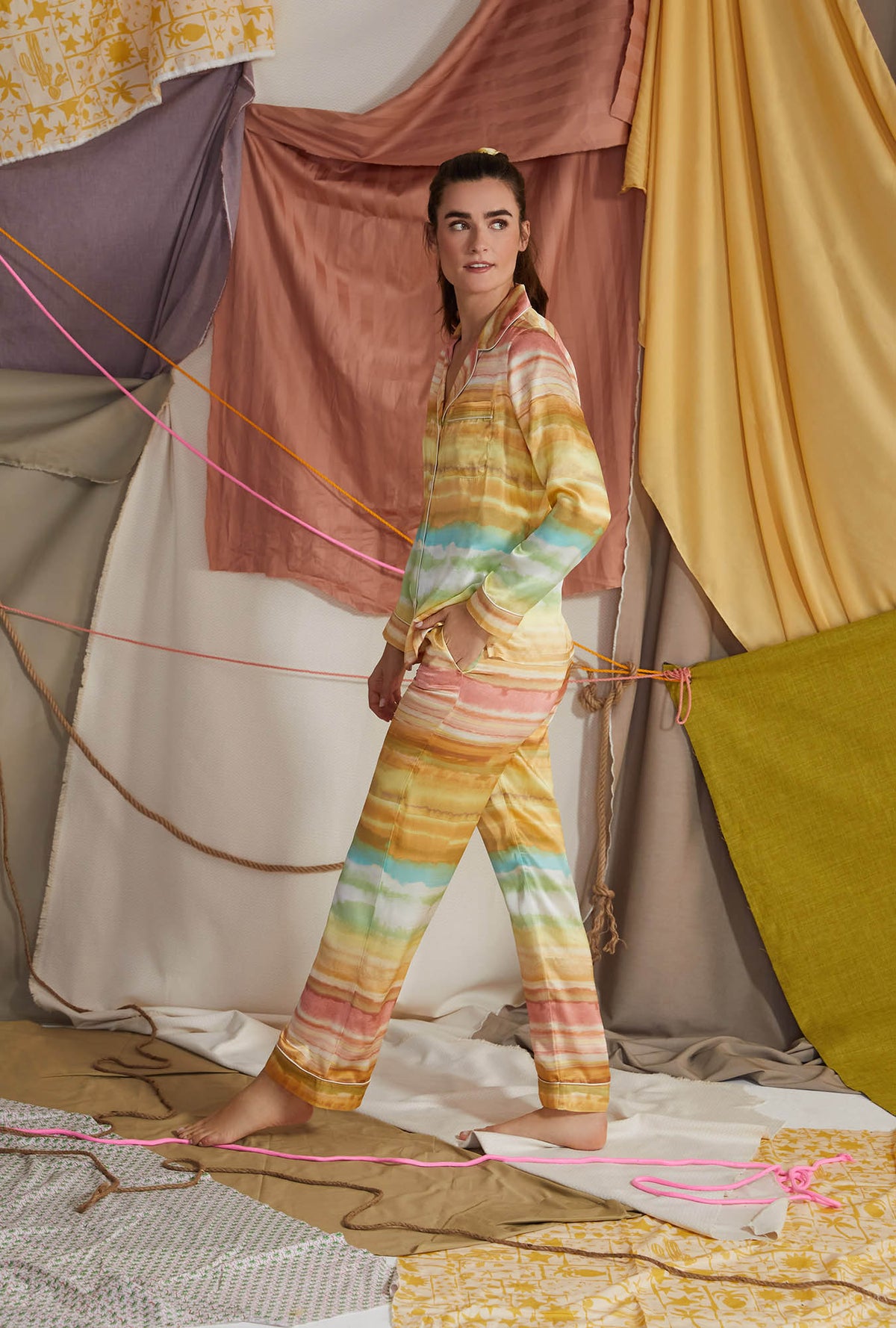 A lady wearing multi color long sleeve classic woven washable silk pj set with island sunset print.