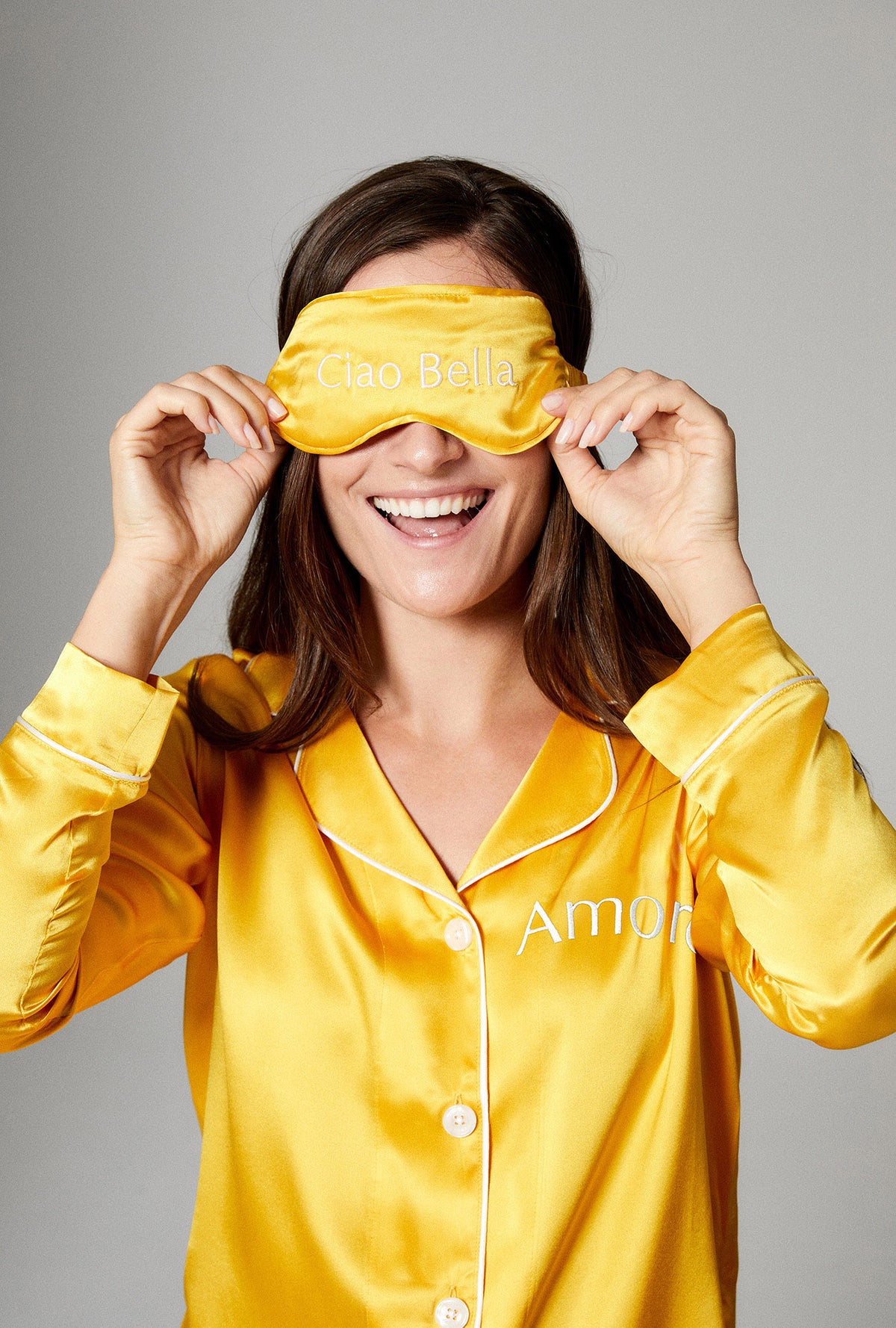 A lady wearing a gold color sleep mask