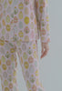 A lady wearing pink long sleeve pj set with egg hunt print