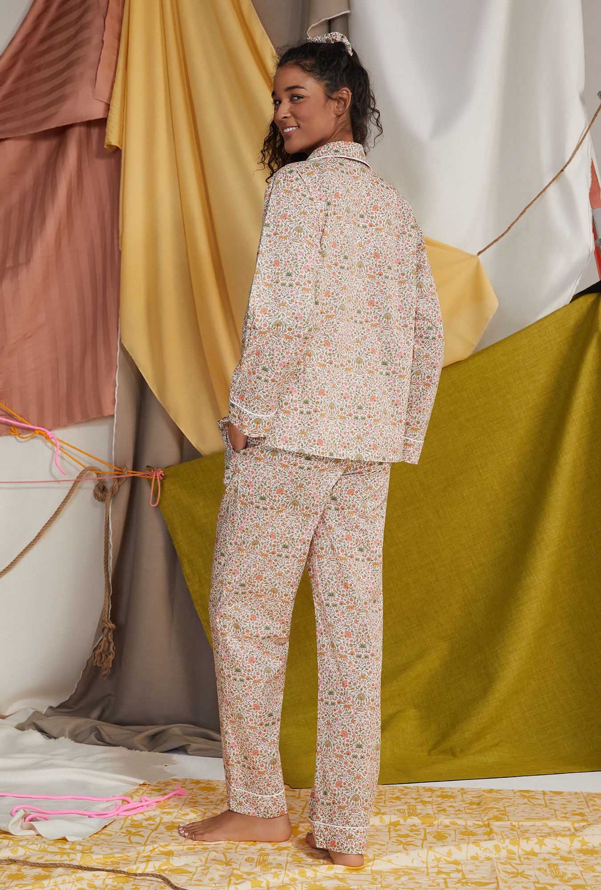 A lady wearing multi color long sleeve tana lawn classic pj set with imran print.