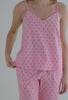 A lady wearing pink tank cropped pj set with corsage print