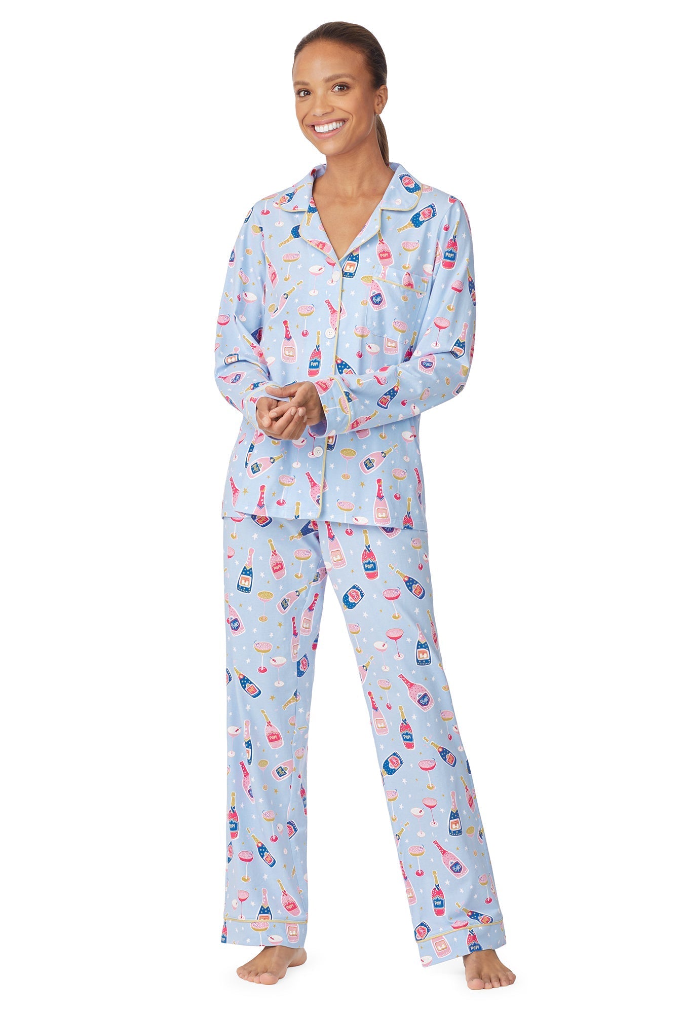 A lady wearing a blue long sleeve pj set with champagne pattern.