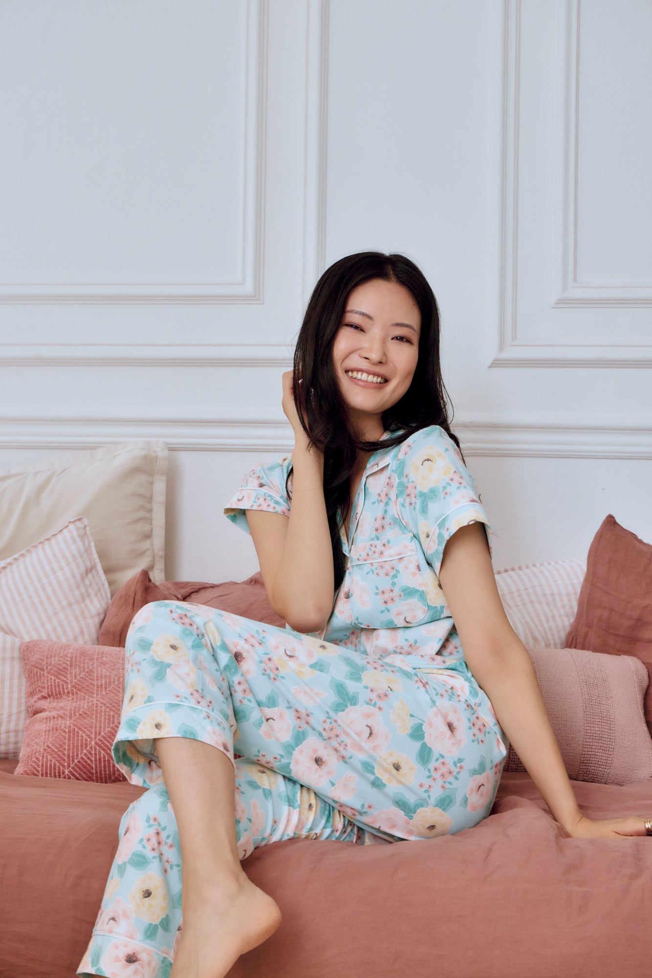 A lady wearing blue short sleeve classic cropped pj set with floral design