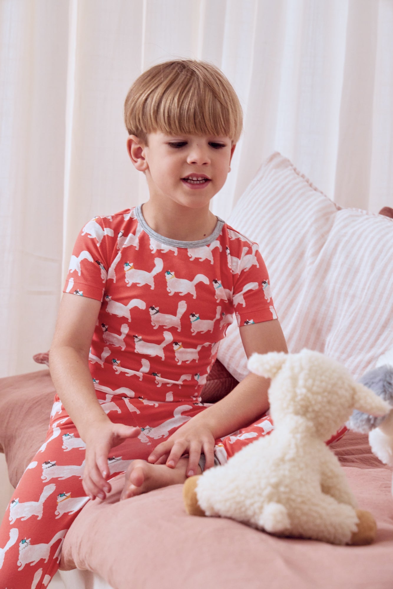 A boy wearing a short sleeve pj set with catwalk pattern.
