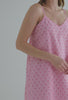A lady wearing pink chemise with corsage print