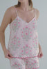 A lady wearing white sleeveless shorty pj set with estate floral print  