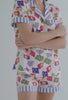A lady wearing white short sleeve classic shorty pj set with nautical flags print.