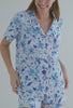 A lady wearing white short sleeve classic shorty pj set with marine meadows print.