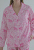 A lady wearing pink long sleeve poplin pj set with elegant print 